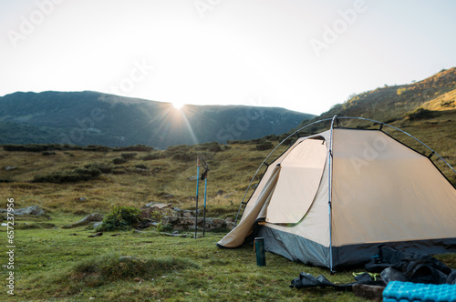 tent set in the mountains at sunset. The concept of active recreation 