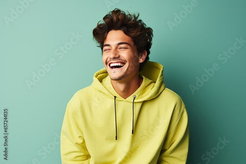 Delighted Young Man in Vibrant Attire Laughing Against a Lively Solid Background. created with Generative AI