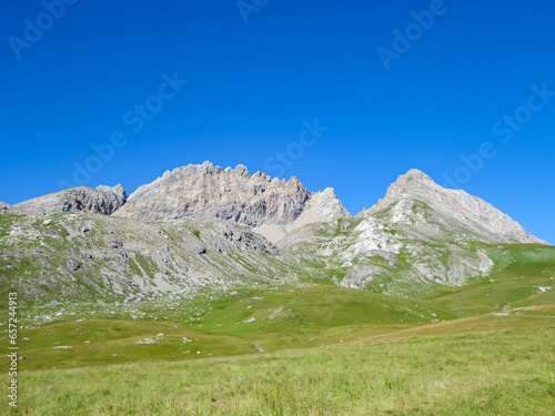 Scenic view of Monte Oserot near rifugio della Gardetta on Italy French border in Maira valley in Cottian Alps, Piedmont, Italy, Europe. Hiking on alpine pasture on sunny summer day in mountains © Chris