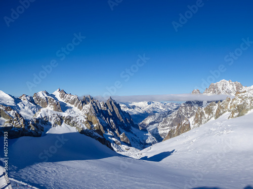 Snow capped Mont Blanc mountain range massif in Alps seen from lift station Pointe Helbronner (Punta Helbronner) in Courmayeur, Aosta Valley, Italy, Europe. Graian Alps on watershed France and Italy