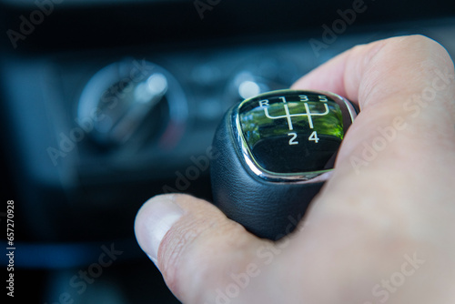 Close-up of a hand on a manual transmission knob. Difficulties and inability to drive a car with a manual transmission.