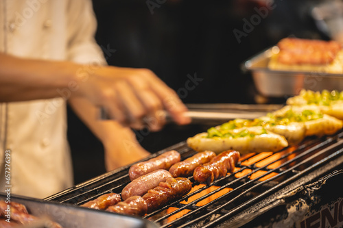 Taiwan hot dog on the stove in street food stall at liuhe night market.The Liuhe Night Market is a tourist night market in Sinsing District, Kaohsiung. It is one of the most popular markets in Taiwan
