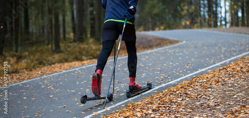 Man ride roller skis in the autumn Park. photo