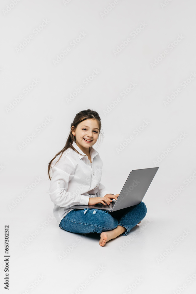 Schoolgirl typing on keyboard using laptop with touch screen, online course of educational lessons at home. Distance learning, distance video conferencing. Schoolgirl studying at school Schoolgirl typing on keyboard using laptop with touch screen, online course of educational lessons at home. Distance learning, distance video conferencing. Schoolgirl studying at school
