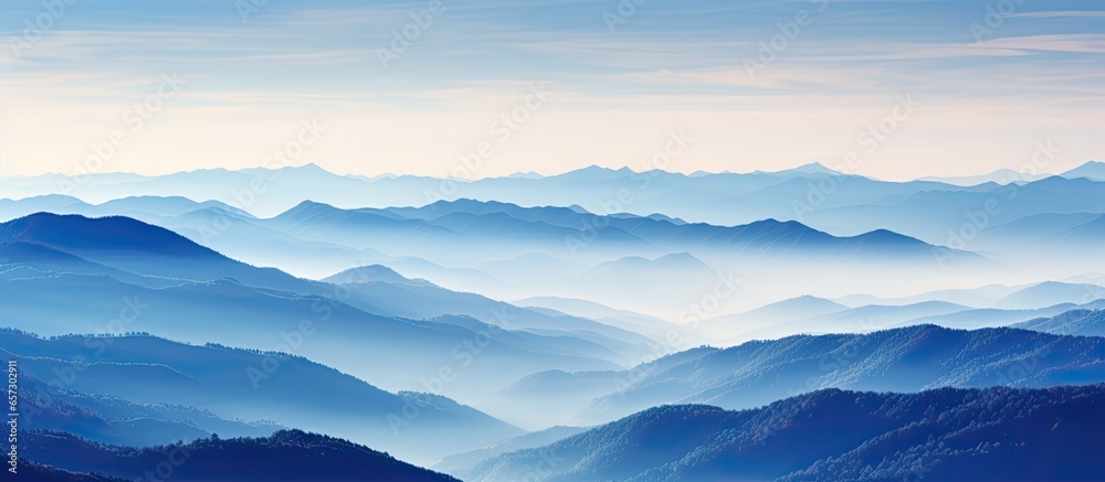 Swiss Alps blue mountain silhouettes seen from Mt Niesen during an autumn evening With copyspace for text