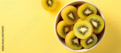 Sliced ripe kiwi in bowl from above With copyspace for text