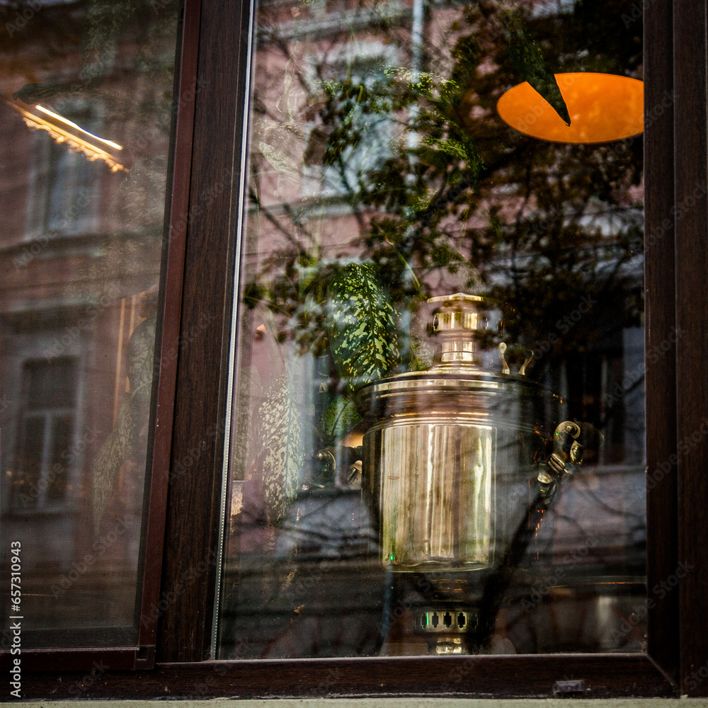 Samovar in window, old city reflection on glass
