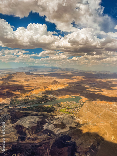 Aerial photography of the Nevada desert  United States  you can see the mountains  the desert plain  a lake with a river  the clouds and the sky.