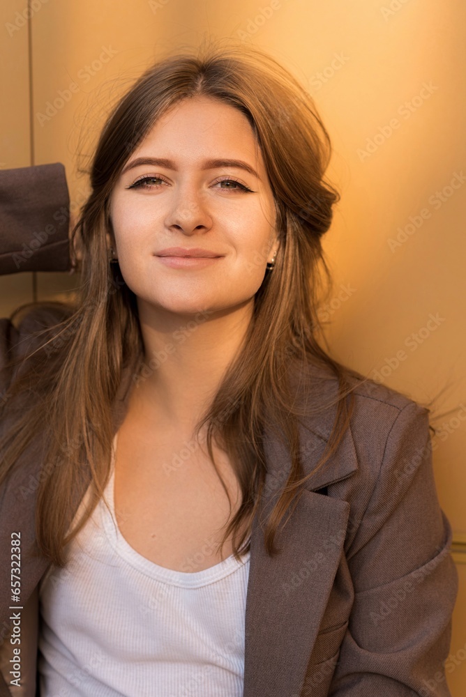 Portrait of a Caucasian attractive and happy young woman in casual clothes in the city while walking on a sunny day. The concept of style, fashion, youth and lifestyle Portrait of a Caucasian attractive and happy young woman in casual clothes in the city while walking on a sunny day. The concept of style, fashion, youth and lifestyle