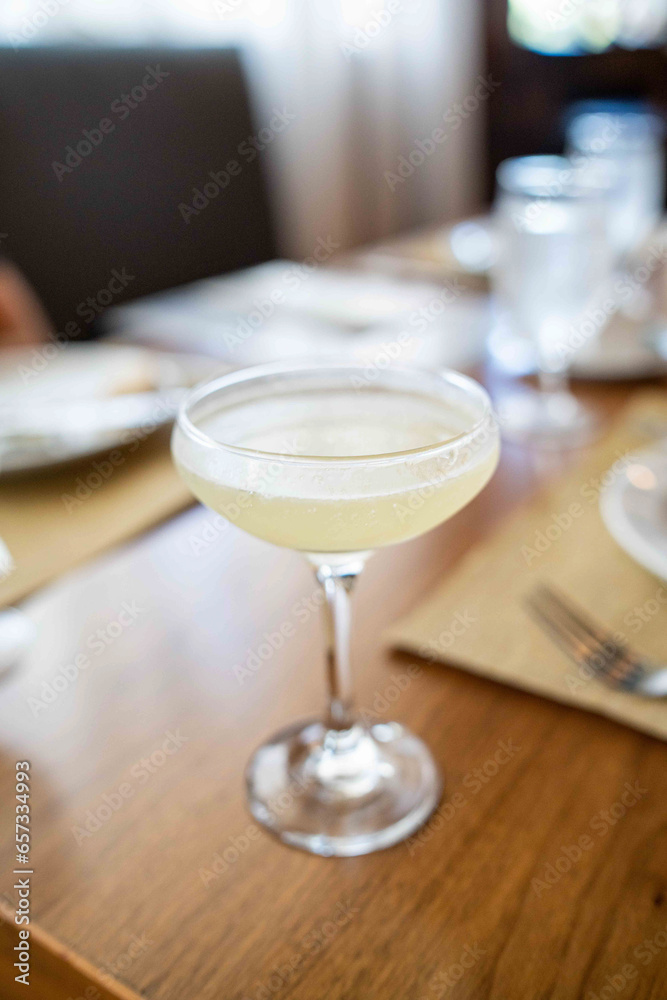 light and delicious pisco sour cocktail on wooden table at fine dining italian restaurant