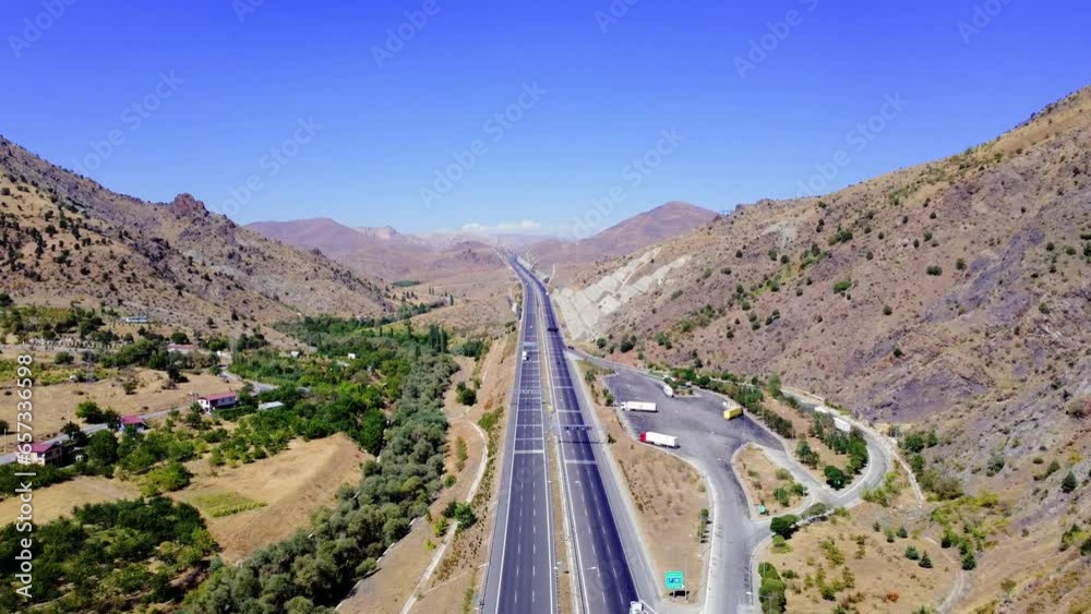Aerial view of a amazing green landscape highway that runs through the mountains