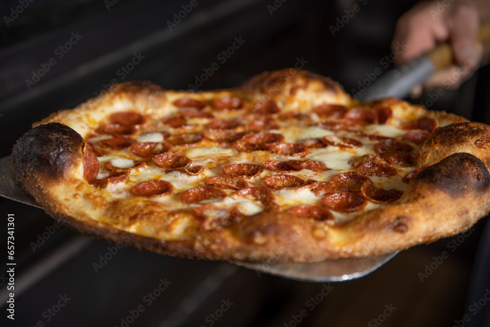 Pepperoni Pizza coming out of oven Pepperoni Pizza coming out of oven