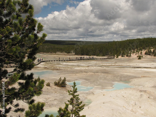 Yellowstone National Park grand view of the geyser basin through the pines over looking the basin and mountains.  photo