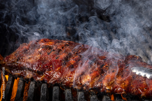 Ribs on a grill with smoke