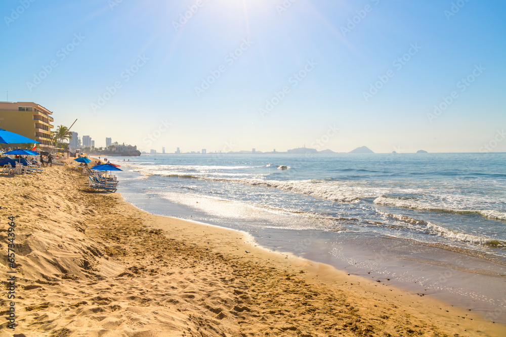 A hot afternoon sun highlights the sandy beaches and resorts along the Zona Dorado or Golden Zone of the Mexican Riviera at Mazatlan, Mexico.