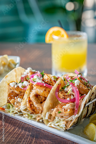 Blackened shrimp tacos with pickled red onion and mac and cheese.