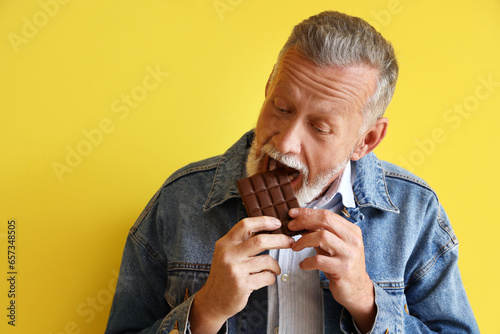 Mature man eating tasty cho...
