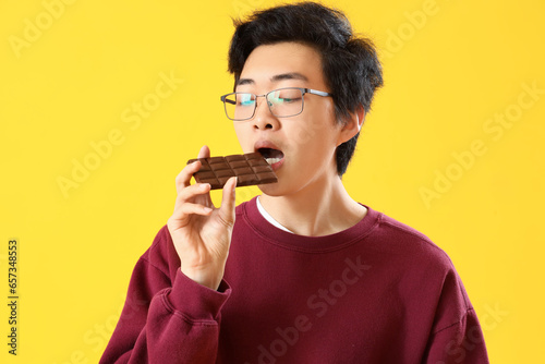 Young Asian man eating tast...