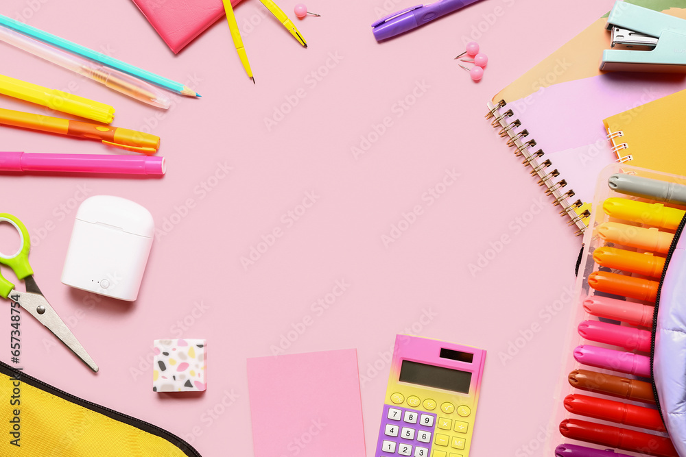 Frame made of calculator and different stationery on pink background Frame made of calculator and different stationery on pink background