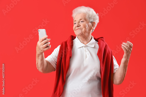 Senior woman with mobile ph...
