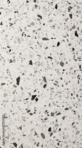 Texture of terrazzo concrete, characterized by a speckled effect created by an array of contrasting light and dark aggregates.