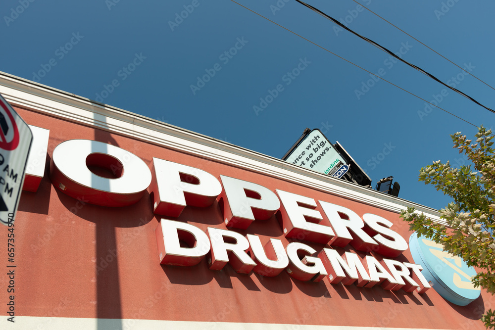 part of exterior sign of Shoppers Drug Mart and logo with billboard and ...