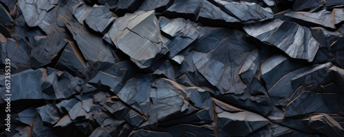Detailed shot of jagged volcanic basalt, featuring shades of midnight blue and burnt sienna with jagged, sharp edges and a co, grainy texture.