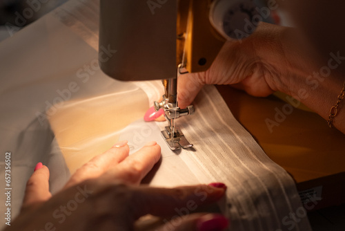 Fototapeta Naklejka Na Ścianę i Meble -  Woman working on a sewing machine