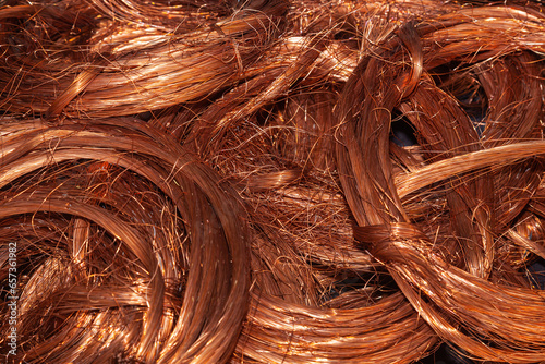 Scrap copper stripped cables twisted and collected in a heap, close-up.
