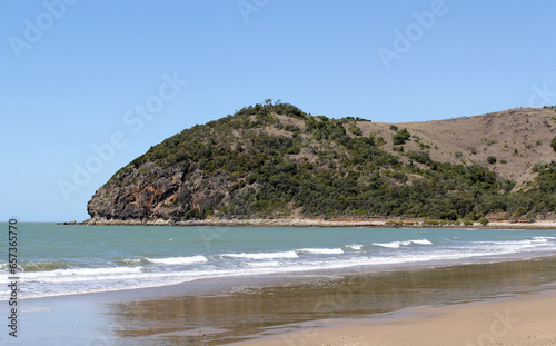 Kemp Beach with sand, the ocean, a mountain and trees at Yeppoon in Queensland, Australia