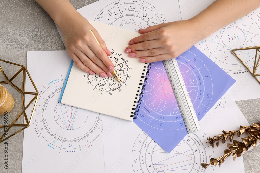 Astrologer using zodiac wheel for fate forecast at table, top view. Fortune telling Astrologer using zodiac wheel for fate forecast at table, top view. Fortune telling