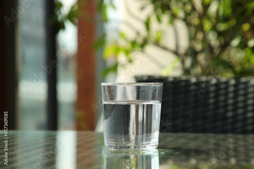 Glass of fresh pure water on table