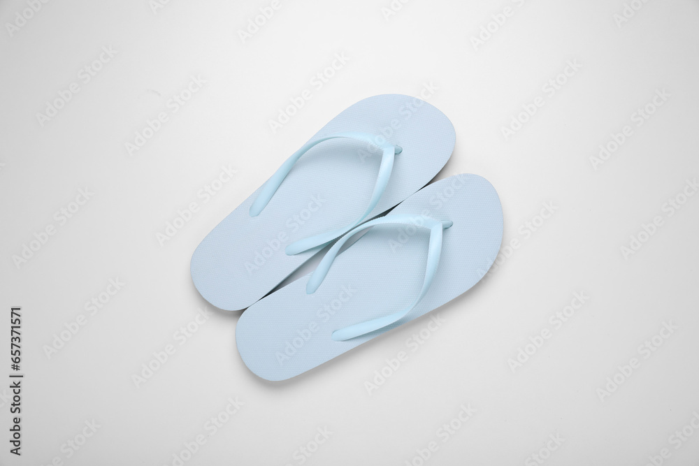 Light blue flip flops on white background, top view Light blue flip flops on white background, top view