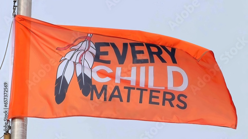 An orange flag with the text Every Child Matters during the National Day for Truth and Reconciliation. Concept: Orange Shirt Day. photo