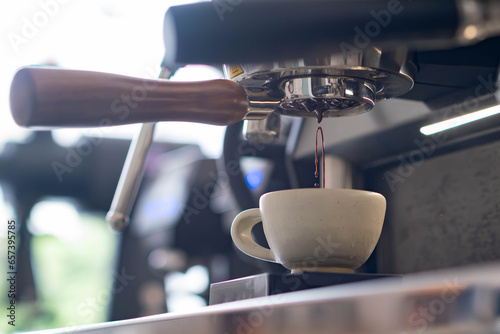 pull espresso shot with bottomless portafilter on a professional coffee machine