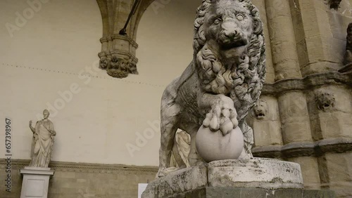 Lion sculpture of Flaminio Vacca showcased in Loggia dei Lanzi, an open-air sculpture gallery of antique and Renaissance art in Piazza della Signoria, a monumental square of Florence, Italy. photo