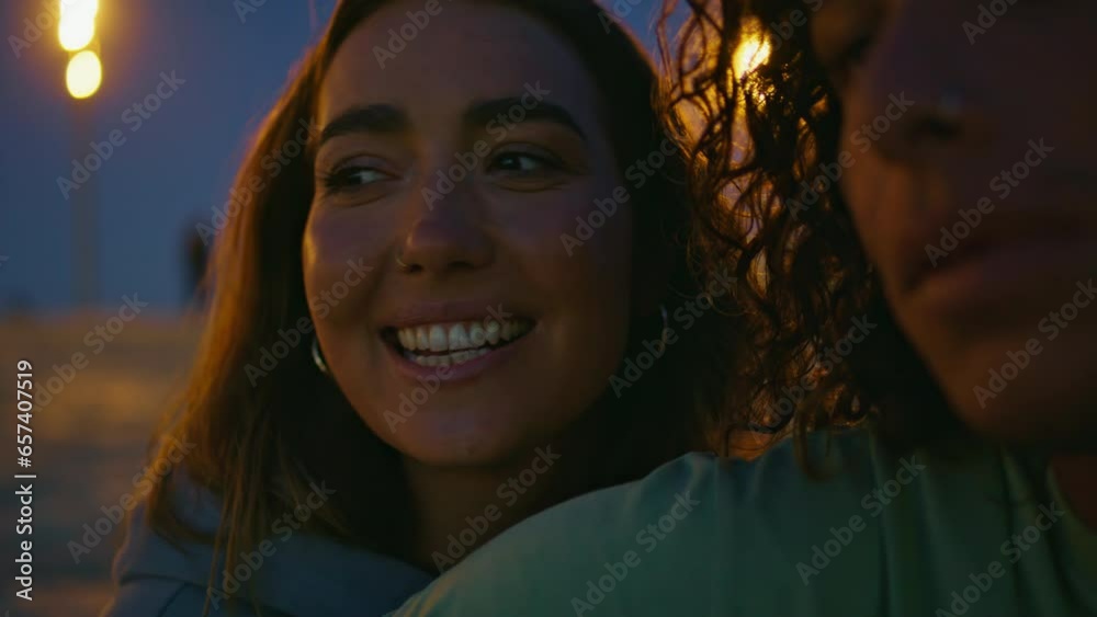 Young woman face singing song at night beach closeup. Teenager playing guitar Young woman face singing song at night beach closeup. Teenager playing guitar