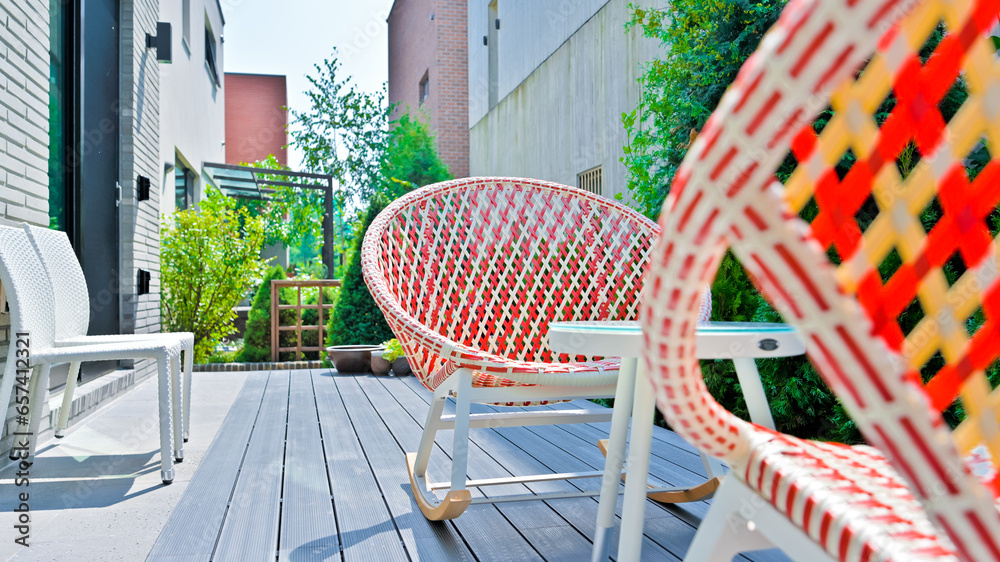 Colorful rattan chairs are always available in resort accommodations - obrazy, fototapety, plakaty 