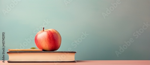 copy space image on isolated background with an apple on top of books