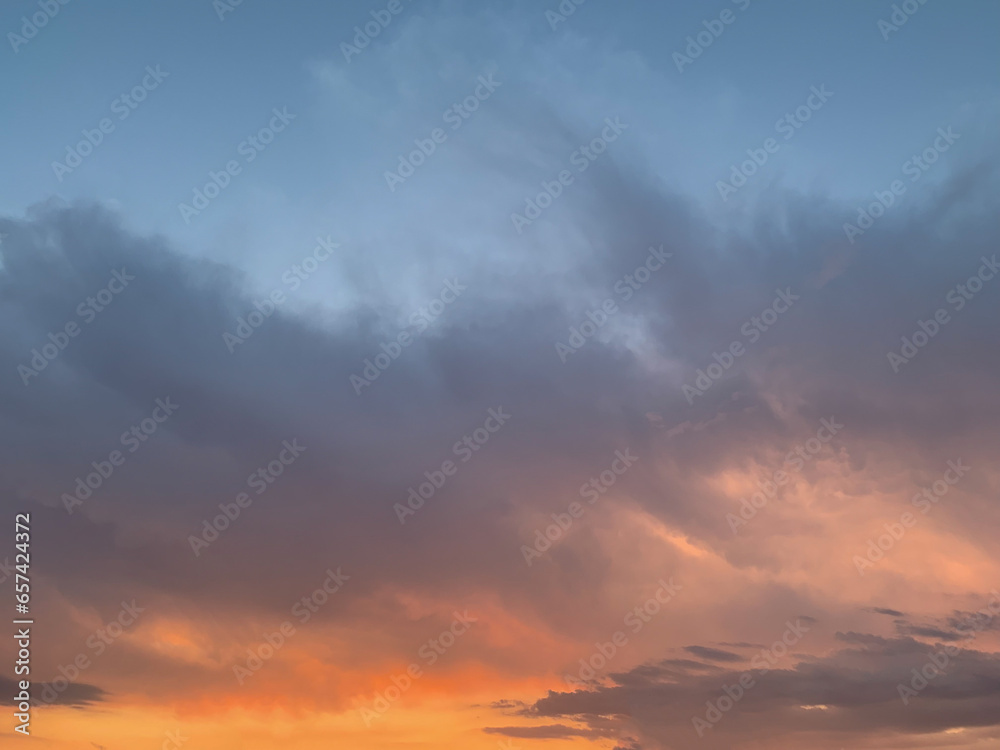 Beautiful colorful golden hour sky with dark clouds.