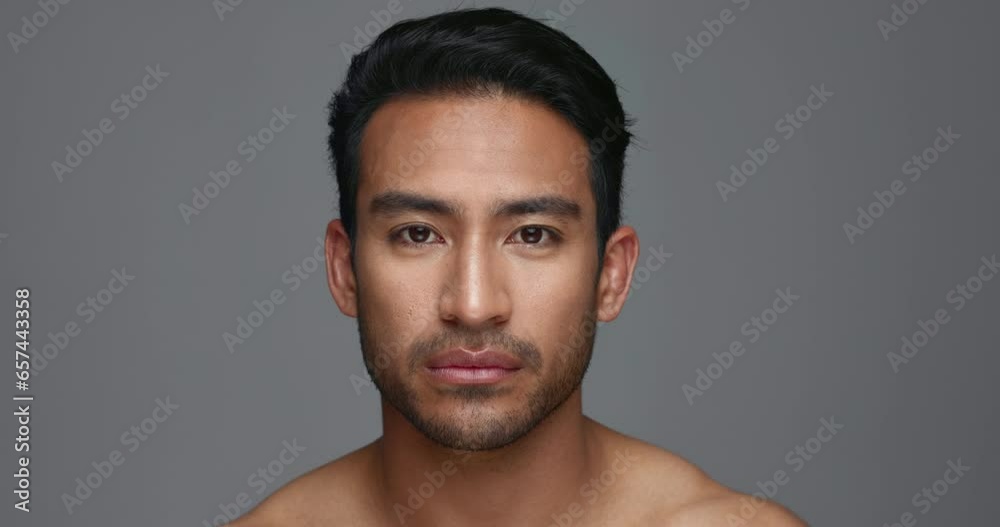 Face, cosmetics and Asian man with beauty, skincare and dermatology on a grey studio background. Portrait, Japanese person and model with wellness, luxury treatment and spa grooming with aesthetic