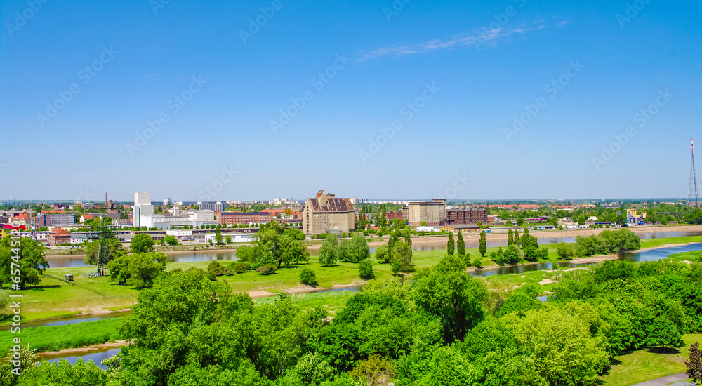 Magdeburg, Germany. Panoramic bird view over the Elbauen city park, Elbe river and old industrial harbor. Cityscape in the historical downtown in Magdeburg at sunny day and blue sky.