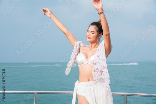 Portrait of beautiful woman in bikini standing on Yacht having fun in a sunny day, Summer holiday sea people concept.