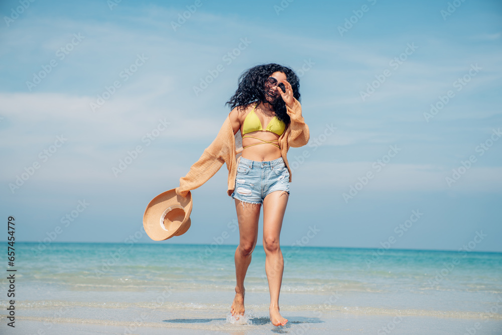 Happy beauty woman in bikini walking and playing on the beach having fun in a sunny day, Beach summer holiday sea people concept.