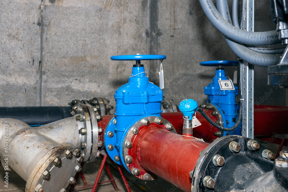 Water treatment plant water pump system. Valve and pumps in an industrial room.