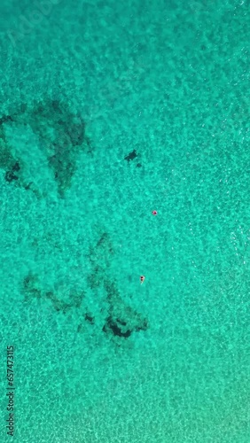 Aerial view of to women in the clear tropical water