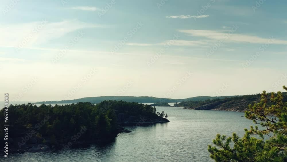 Russia, Karelia, Lake Ladoga, Koyonsaari. View of the coast of the island in a cold lake. Beautiful nature of the Republic of Karelia. Stunning panoramic view of the Ladoga Skerry Islands. 4K Russia, Karelia, Lake Ladoga, Koyonsaari. View of the coast of the island in a cold lake. Beautiful nature of the Republic of Karelia. Stunning panoramic view of the Ladoga Skerry Islands. 4K