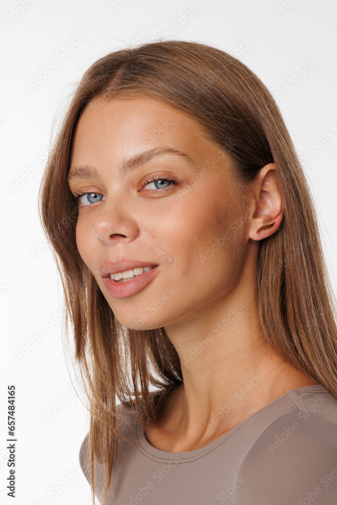 Beautiful young girl with fresh healthy skin. Woman advertise ear-rings. White background. Earrings, ear caffs closeup. Blond european woman with long hair with big lips, pretty smile. Cosmetology Beautiful young girl with fresh healthy skin. Woman advertise ear-rings. White background. Earrings, ear caffs closeup. Blond european woman with long hair with big lips, pretty smile. Cosmetology
