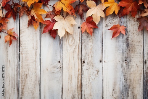 Fall background of autumn leaves, space for text over a white wooden background