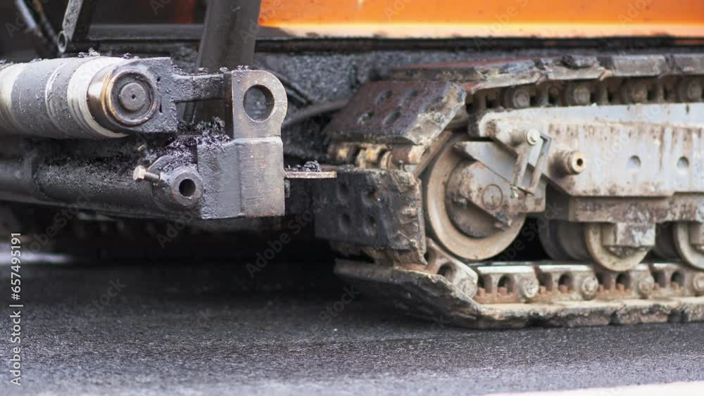 Tracked Paver Machine During Asphalt Pavement Works for Road Repairing in Berlin Tracked Paver Machine During Asphalt Pavement Works for Road Repairing in Berlin
